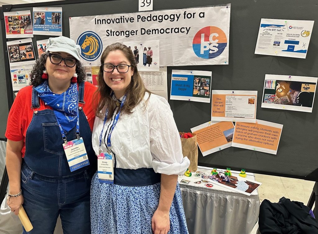 Two smiling female educators stand in front of their conference booth titled “Innovative Pedagogy for a Stronger Democracy” with the Loudoun County Public Schools logo.